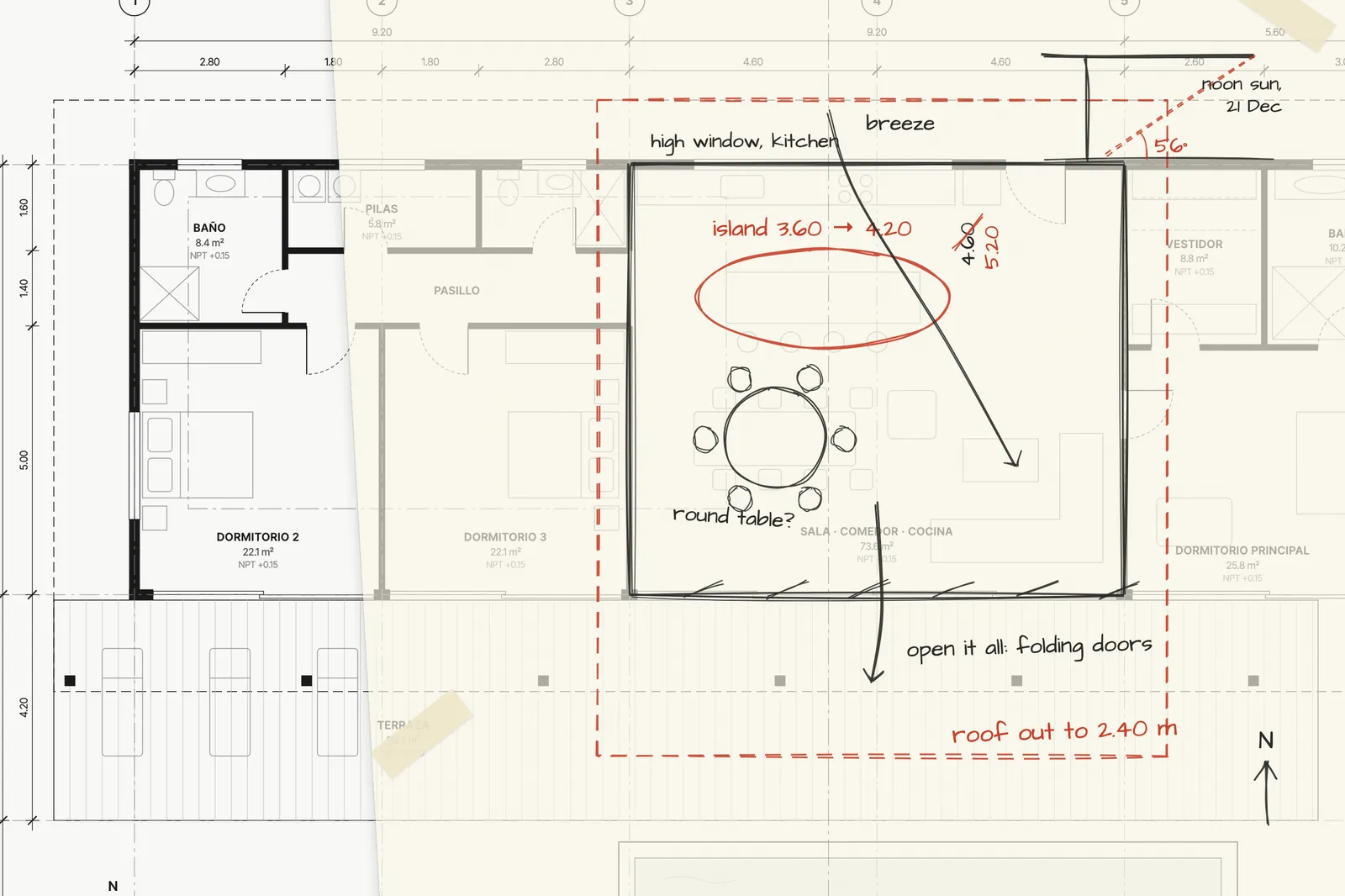 Trace paper over a printed floor plan with red and graphite pencil notes: a longer island, a deeper roof and the December noon sun