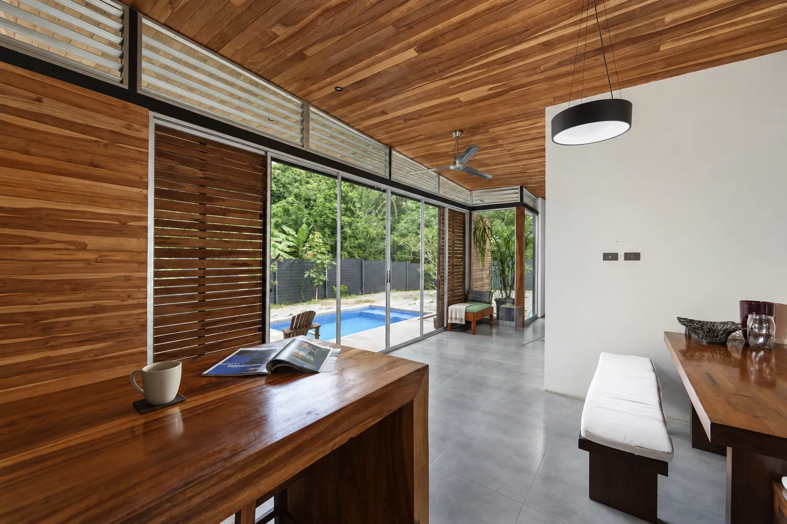 Solid wood desk in the bedroom, facing sliding glass doors to the pool